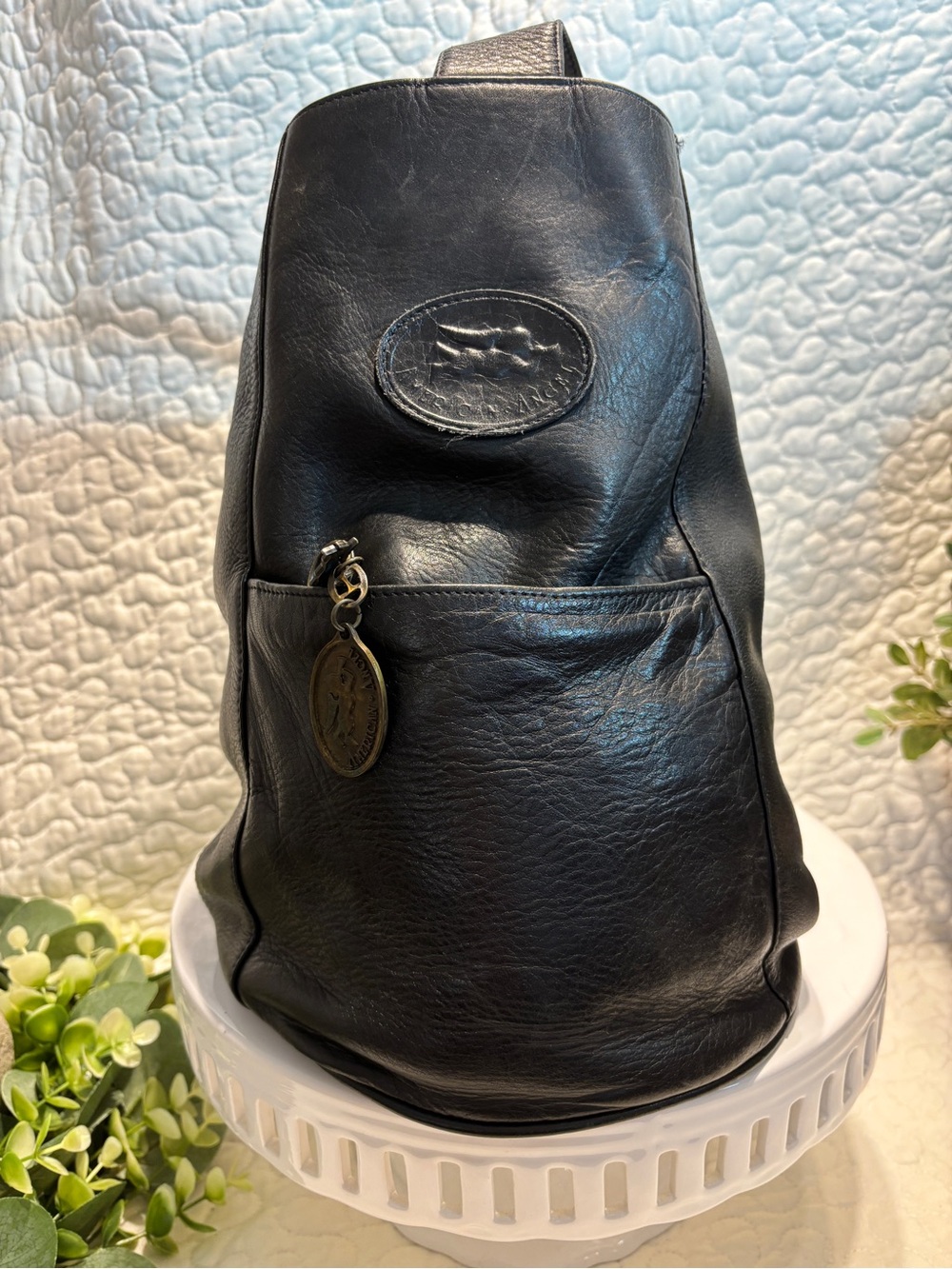 Vintage Black Leather Sling Bag with Decorative Medallion